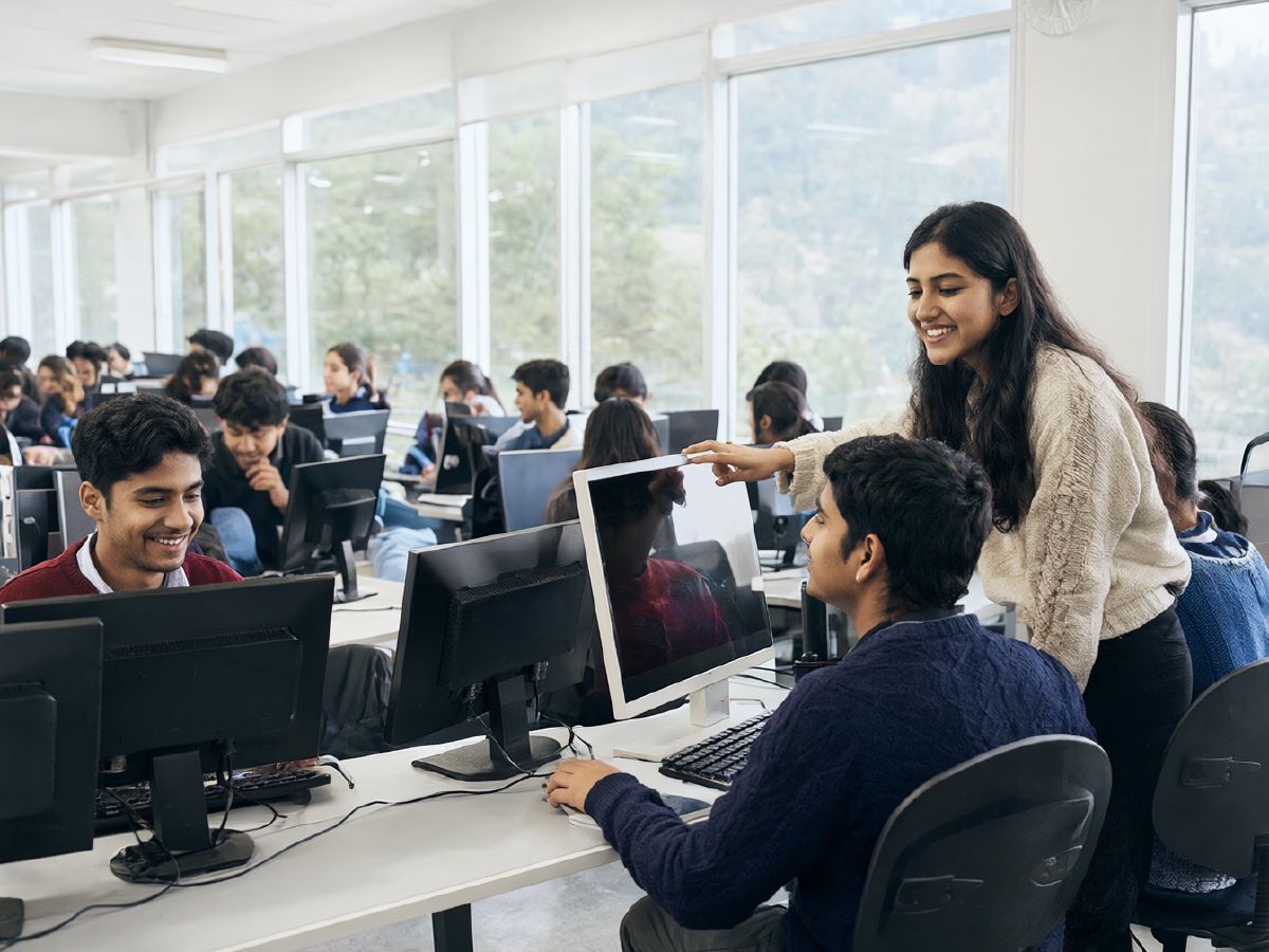 Photo (AI-generated, illustrative): an instructor helps students working at computers in a college lab
